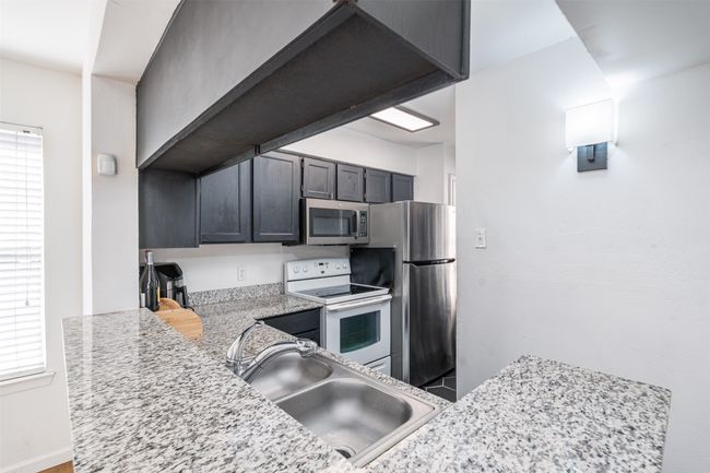Kitchen featuring stainless steel appliances and a sink | Image 8