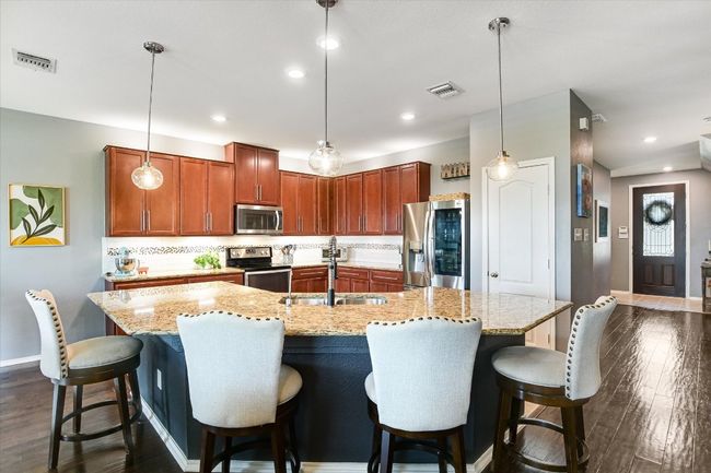 Kitchen with appliances with stainless steel finishes, baseboards, a sink, backsplash, and recessed lighting | Image 4