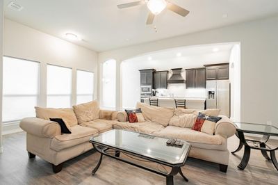 Living room with sink, dark hardwood / wood-style floors, and ceiling fan | Image 3