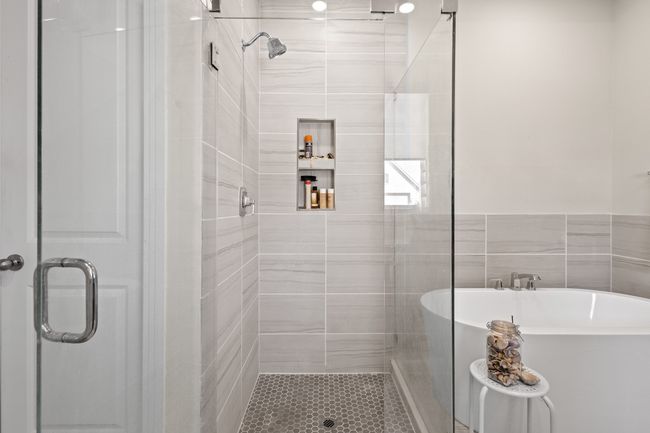 Bathroom featuring a shower stall and a freestanding bath | Image 13