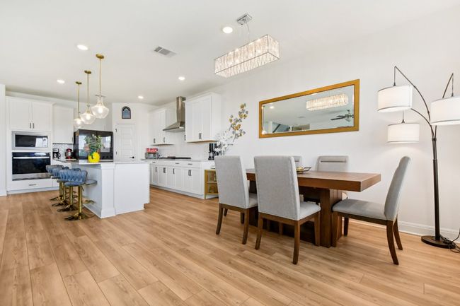 Dining room with light wood-type flooring and recessed lighting | Image 6