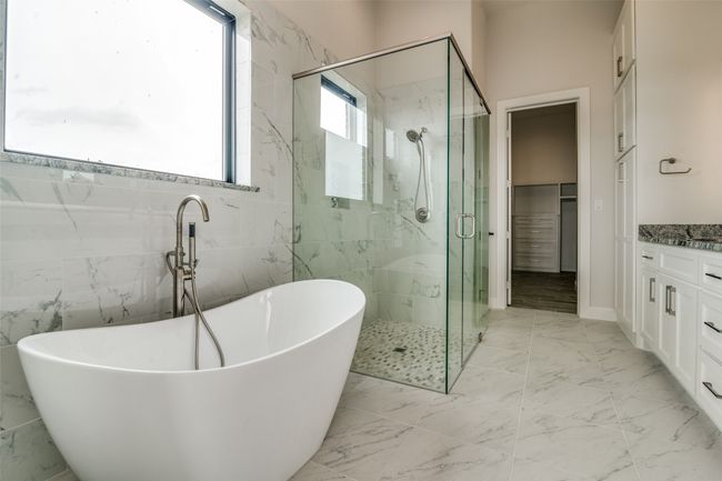 Bathroom with tile walls, tile flooring, and vanity | Image 13