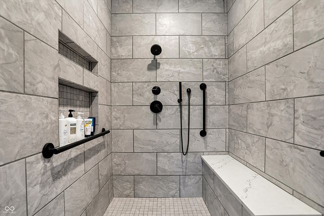 bathroom featuring a tile shower | Image 29