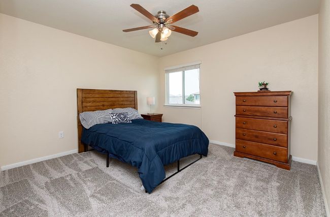 Carpeted bedroom featuring baseboards and a ceiling fan | Image 18
