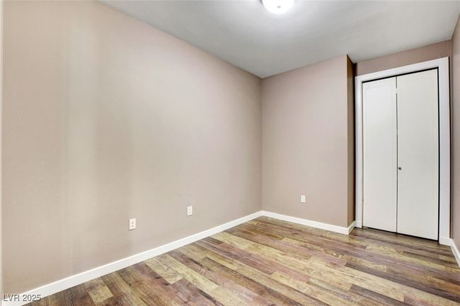Second bedroom featuring baseboards, wood finished floors, and a closet | Image 24