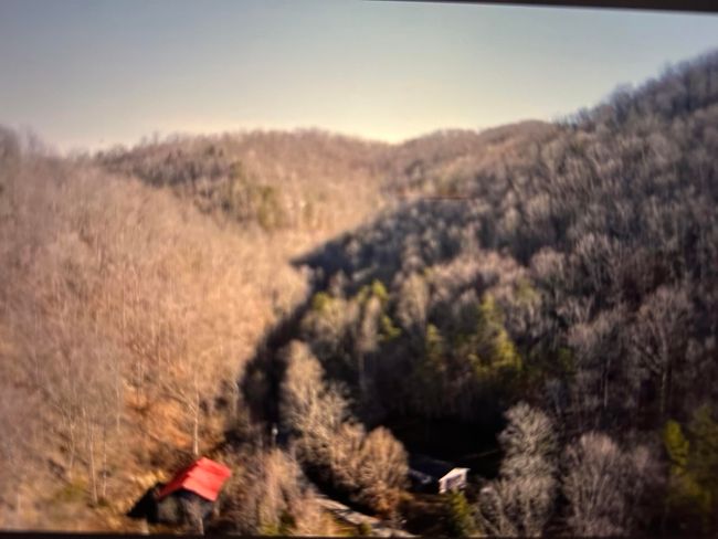 Barn has the red roof and home is to the right of the barn. | Image 5