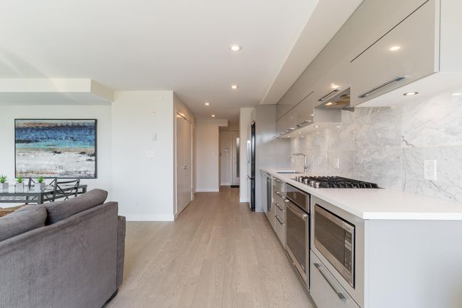 Kitchen with gray cabinets, modern cabinets, stainless steel appliances, and a sink | Image 7