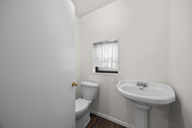 Bathroom with wood finished floors, toilet, and baseboards | Image 14