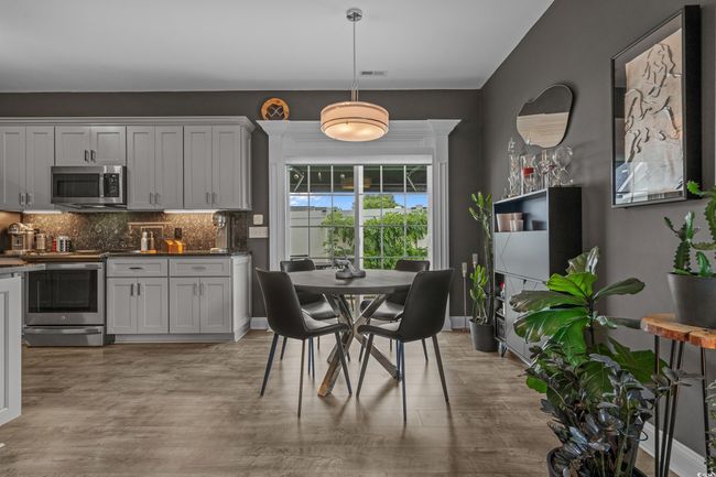 Dining room with light wood finished floors | Image 11