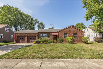 Single story home with a garage and a front lawn | Image 1