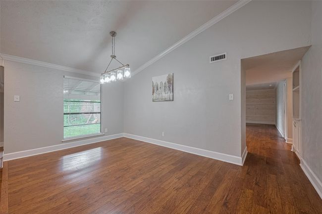Hall leading to kitchen and family room is located right off the dining room | Image 7