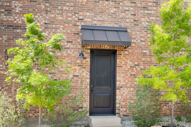 Doorway to property featuring brick siding | Image 33
