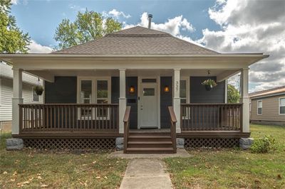 Bungalow-style house featuring a front yard and a porch | Image 1