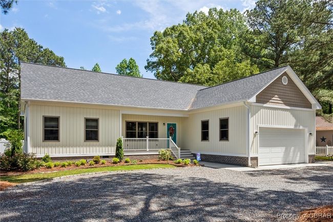Ranch-style house with a garage, a shingled roof, driveway, a porch, and crawl space | Image 5