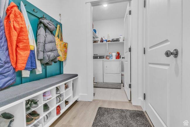 Mudroom featuring washing machine and clothes dryer and wood finished floors | Image 25