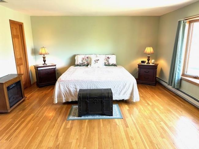 Bedroom with multiple windows and hardwood / wood-style floors | Image 11