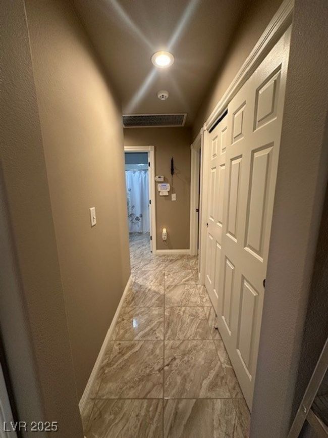 Corridor featuring light marble finish flooring and baseboards | Image 6