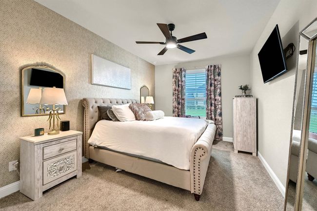 Bedroom featuring baseboards, ceiling fan, and light colored carpet | Image 31