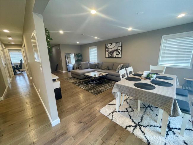 Living room wood finished floors, and recessed lighting | Image 10