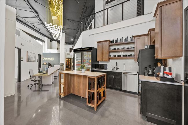 Kitchen featuring a sink, open shelves, dishwasher, and a towering ceiling | Image 5