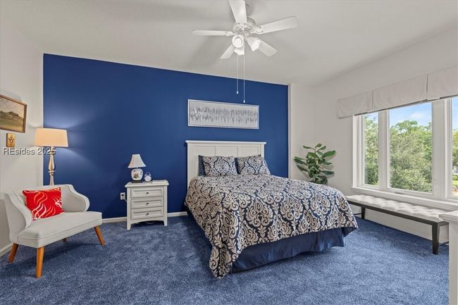It's said that blue in bedrooms is the most restful! This is the master suite - complete with a pretty view of the courtyard gardens, large walk-in closet and en suite full bathroom. | Image 15