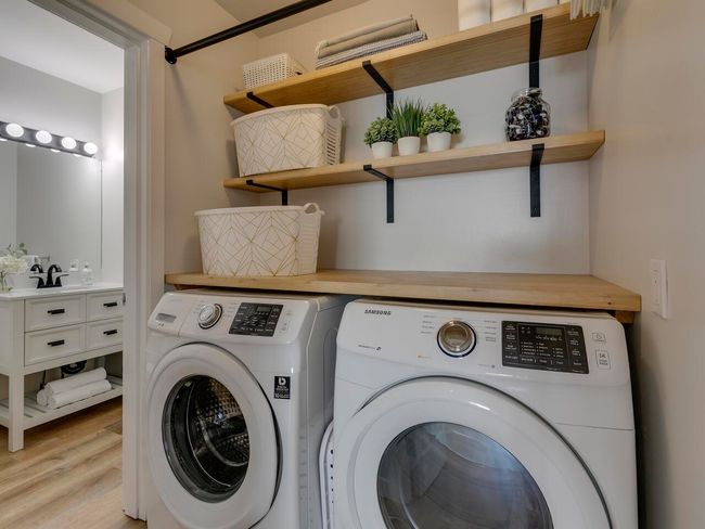Laundry room featuring light wood finished floors, laundry area, and separate washer and dryer | Image 17