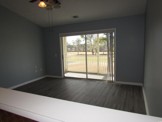 View from the kitchen towards the living room with a ceiling fan, and LVP flooring. | Image 28