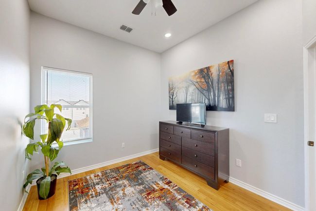 bedroom or office featuring light wood finished floors, a ceiling fan, baseboards, and recessed lighting | Image 17