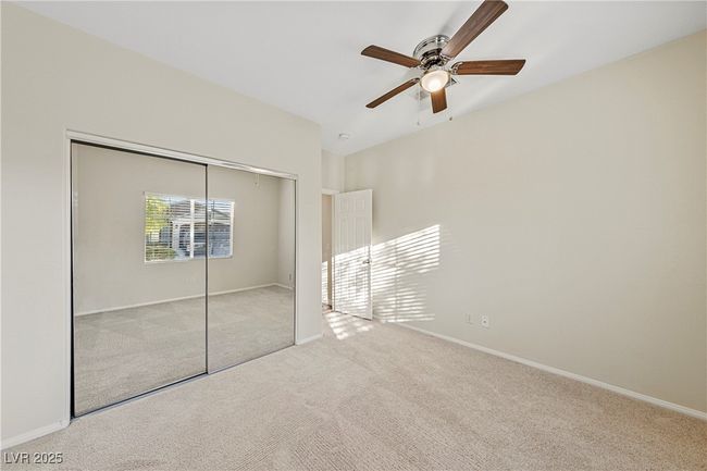 Unfurnished bedroom with carpet floors, a closet, and ceiling fan | Image 15