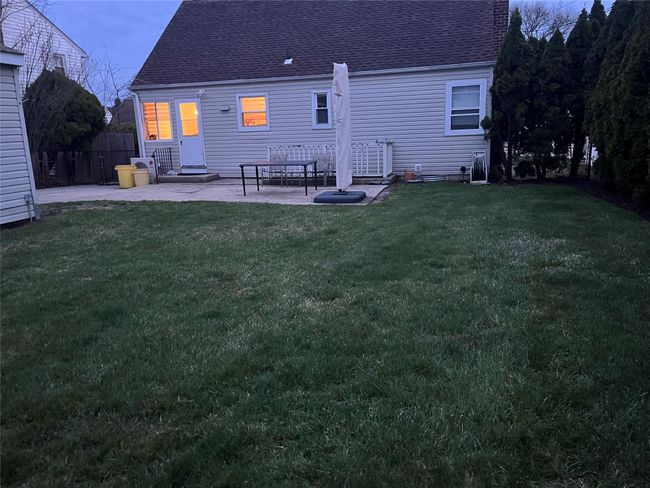 Back of house featuring a patio area, a shingled roof, and a lawn | Image 20