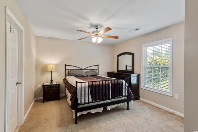 Bedroom with light carpet and ceiling fan | Image 28