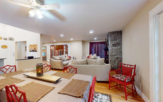 Dining area featuring light wood-style floors, recessed lighting, a ceiling fan, and baseboards | Image 13