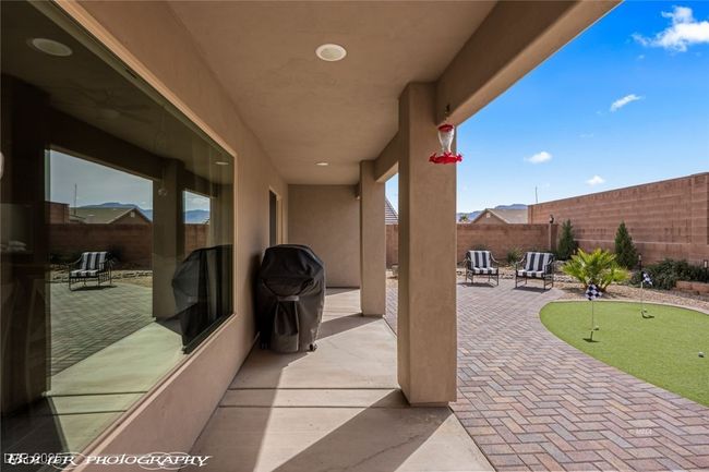 View of patio / terrace featuring a putting green and a fenced backyard | Image 48