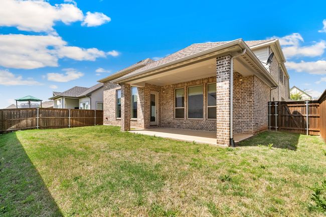 Rear view of property with a fenced backyard, a lawn, a patio area, and brick siding | Image 30