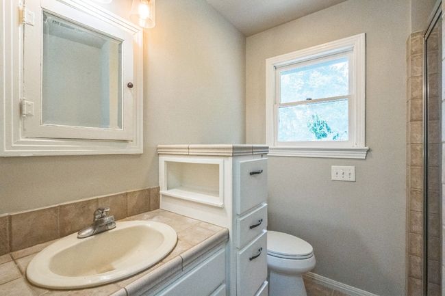 Bathroom featuring vanity and a shower | Image 8