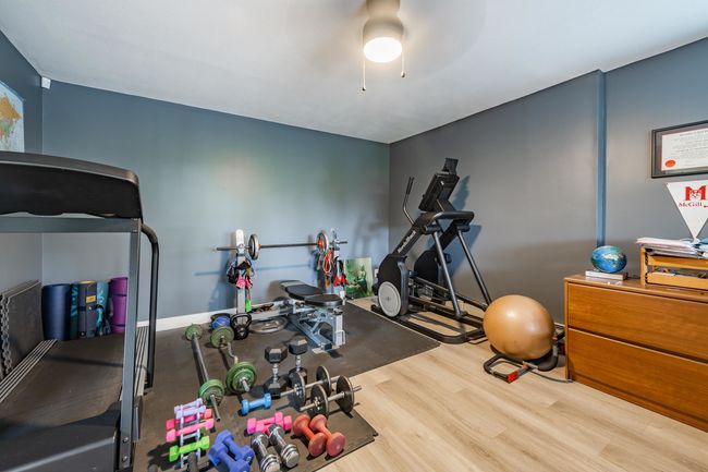 Workout area featuring wood finished floors and a ceiling fan | Image 27