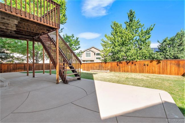 Backyard Stamped Concrete Patio below Deck | Image 24