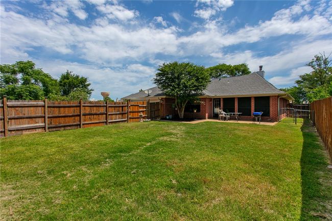 Back of house with a patio area, a chimney, and brick siding | Image 26