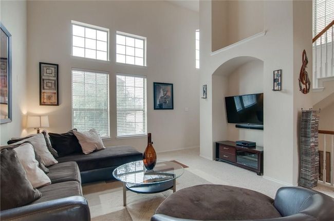 Living room with light carpet and a high ceiling | Image 19