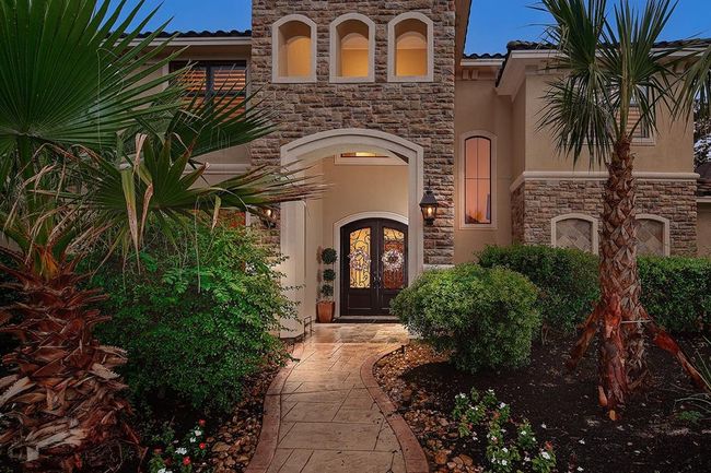 Welcoming front porch with stately, double arched entry doors | Image 4