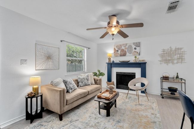 The custom mantle fireplace serves as a charming focal point, adding warmth and character to the living space. | Image 9