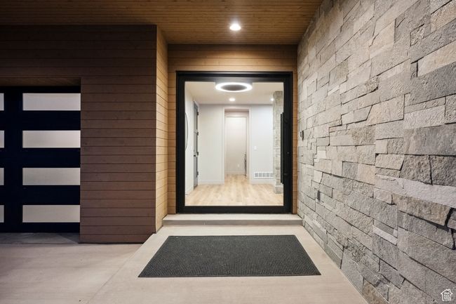 Property entrance with visible vents and a garage | Image 63