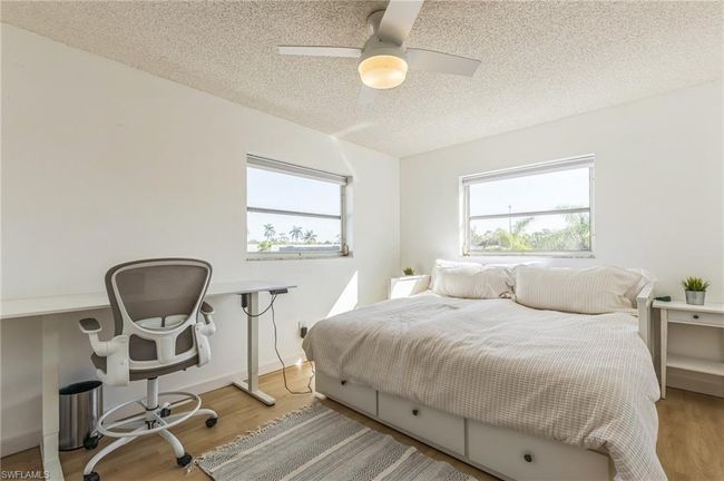 Bedroom featuring a ceiling fan, a textured ceiling, and wood finished floors | Image 29
