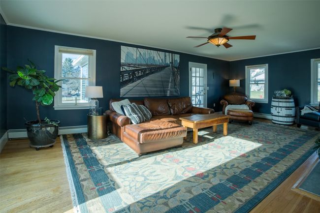 Living room featuring crown molding, hardwood / wood-style floors, and a baseboard radiator | Image 6