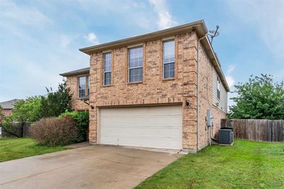 View of front of house with a garage, central air condition unit, and a front yard | Image 3