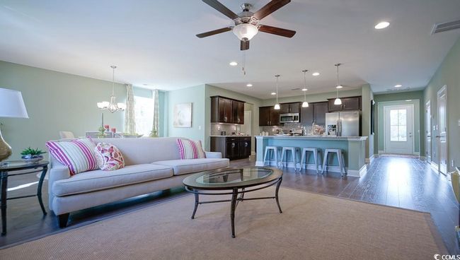 Living area featuring a ceiling fan, a chandelier, light wood-style floors, recessed lighting, and baseboards | Image 13