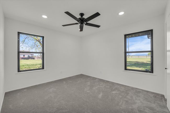 Carpeted spare room with a wealth of natural light, recessed lighting, and ceiling fan | Image 32