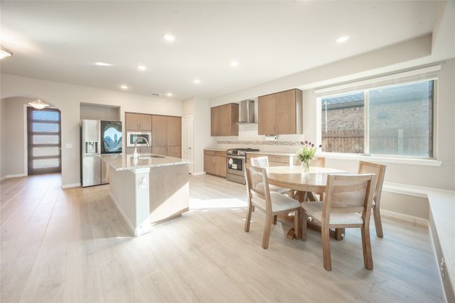 Dining space with light hardwood / wood-style flooring and sink | Image 10