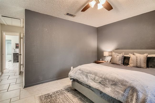Bedroom with attic access, a textured ceiling, and a ceiling fan | Image 11