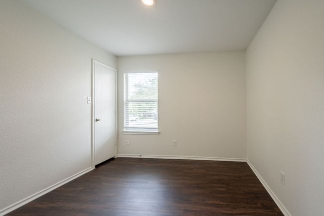 Unfurnished room featuring dark wood-style flooring and baseboards | Image 26